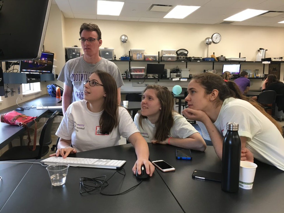 stemcoding students examine a computer programming software.